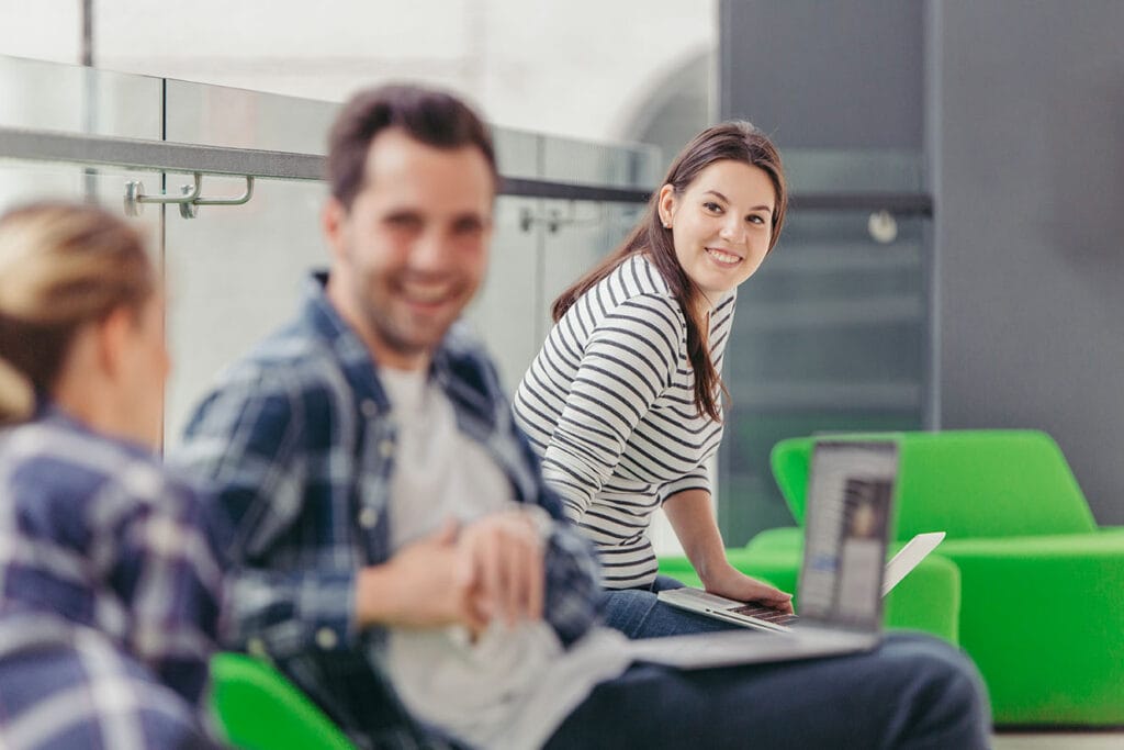 Woman looking at chatting colleagues