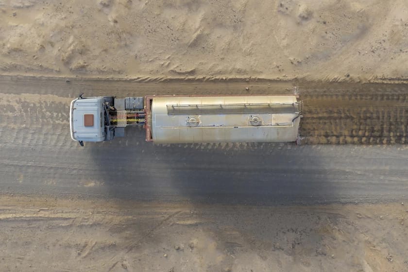 Truck driving on sand road